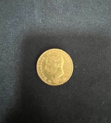 a gold coin sitting on top of a black cloth