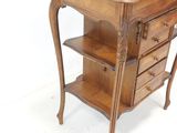 a small wooden table with three drawers on top of it
