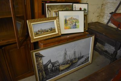 three framed pictures of ships on display in a room