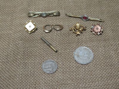 a small amount of jewelry on a table next to a penny