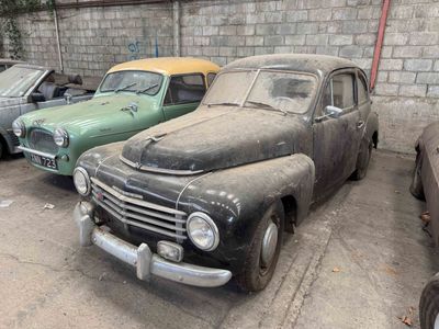 many old cars parked in a parking lot next to each other