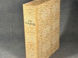 an old book sitting on top of a table next to a black background