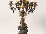 an image of a gold and black candelab with three candles on it