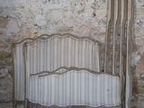 a bed that is sitting in front of a stone wall