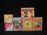 several children ' s board games are lined up on a black surface