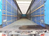 the back of a truck with a flat bed in a warehouse