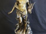 bronze statue of a man holding a book and a dog