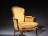 an image of a yellow chair with a yellow cushion in a dark room
