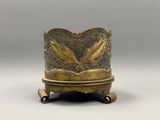 an image of a brass vase with two birds on it