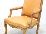 pair of louis xv style carved wood armchairs with orange upholstered upholstered cushions