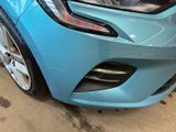 a blue car that is parked in a garage
