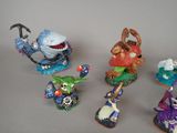 five figurines of different characters on a gray surface