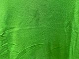 a person wearing a green shirt and black shoes