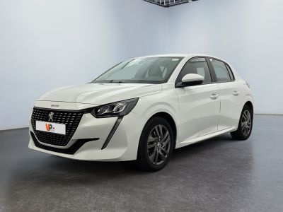 a white car is parked in a room with a black floor