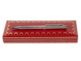 a pen sitting on top of a red box with gold trim