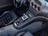 the interior of a sports car with a dashboard and steering controls