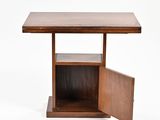 a close up of a wooden table with a small open door