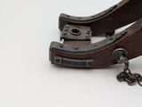 a pair of clamps sitting on a white surface