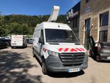 a white van with a red stripe parked in front of a building