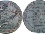 a close up of a coin with a statue on it