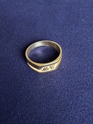 a gold ring with the word arg on it