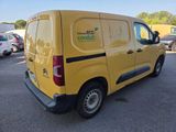 yellow van parked in a parking lot with other cars in the background