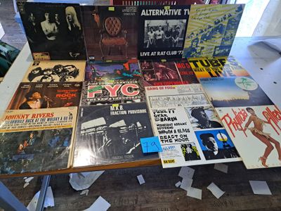 beaucoup de disques posés sur une table recouverte de papiers