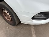 a close up of a white car with a flat tire