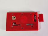 a close up of a red device on a white surface