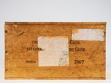 an old wooden box with a label on it sitting on a white surface