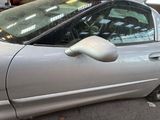 a silver car that is parked on the side of the street