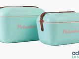 pair of mint green lunch boxes with brown handles on white background