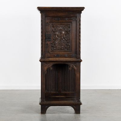 an old wooden cabinet with carvings on the top of it