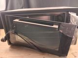 a microwave oven sitting on a table with its door open