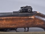 an old rifle with a wooden barrel on a gray background