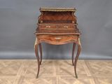an old wooden desk with a drawer on top of it