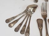 several forks and spoons are arranged in a circle on a table