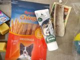 a bag of dog treats, a tube of cheese, and a tube of crackers