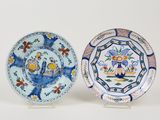 pair of blue and white plates with birds and flowers on them