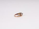 an image of a gold ring on a white surface