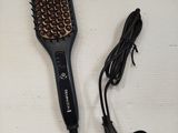 a hair brush and a hair dryer on a table