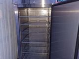 an open refrigerator that is sitting in the corner of a building