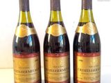 three bottles of wine sitting on top of a table next to each other