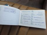 a passport sitting on top of a seat in a car