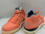a pair of orange sneakers on a white surface