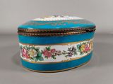 an image of a blue and gold box with flowers on it