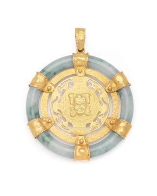 a gold and jade pendant with a medallion in the center