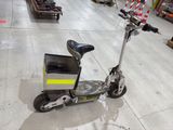 a scooter that is sitting on the floor in a warehouse