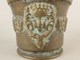 a close up of a vase on a white surface