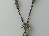 an image of a necklace with a tear shaped pendant on a chain